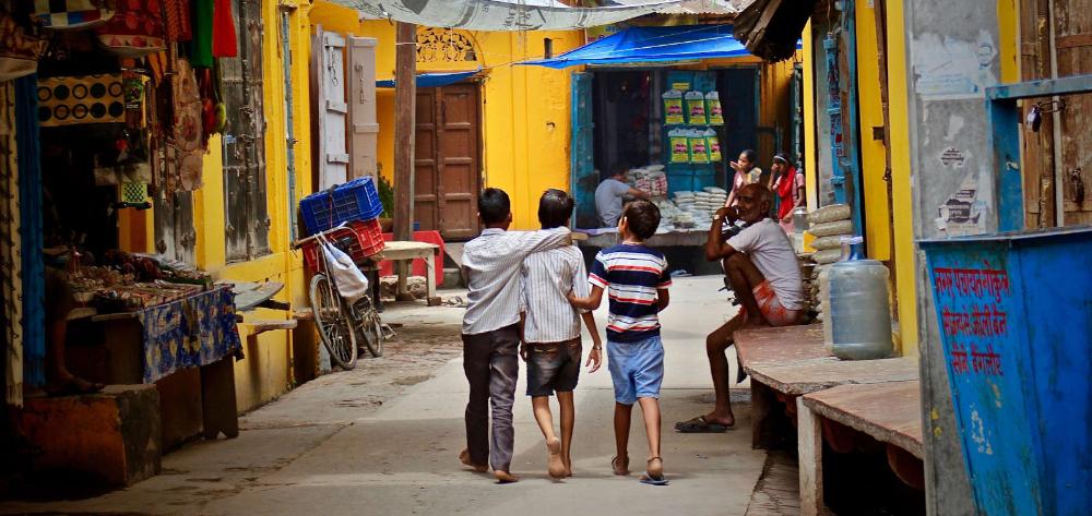 Three kids walking through India
