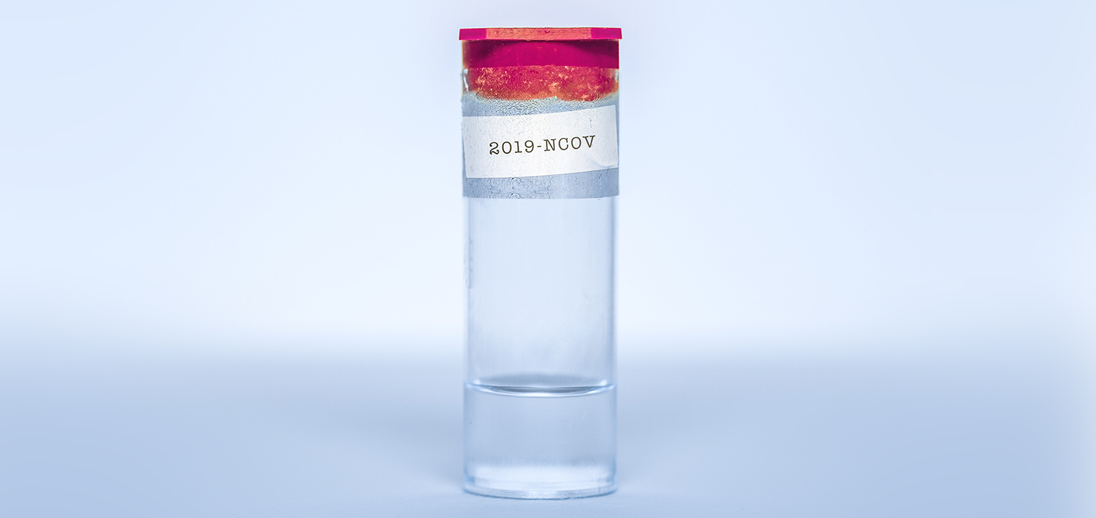 Transparent flask with liquid inside and a 2019-NCOV label taped on it